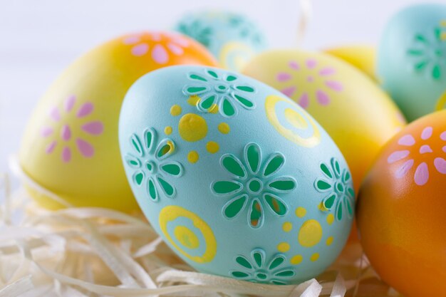 Easter holiday background with eggs. Close up of colorful painted chicken eggs