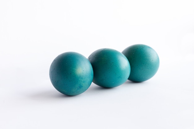 Easter, holidays, tradition, style and minimalism concept - Row of ombre blue Easter eggs isolated on white background