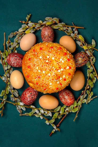 Easter inscription on the background with Easter eggs and bread Willow branches top view