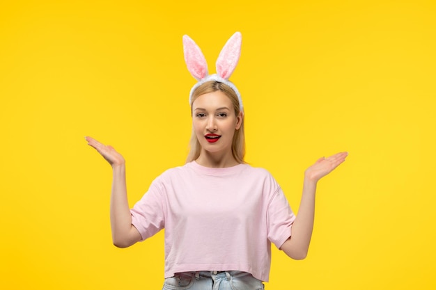 Easter lovely blonde adorable girl with pink bunny ears and red lipstick cheerfully waving hands