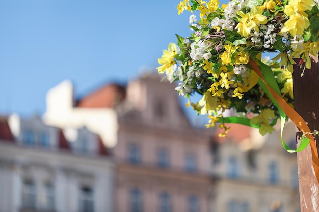 Easter outdoor flower decorations on the streets of Prague blurred historical buildings background copy space