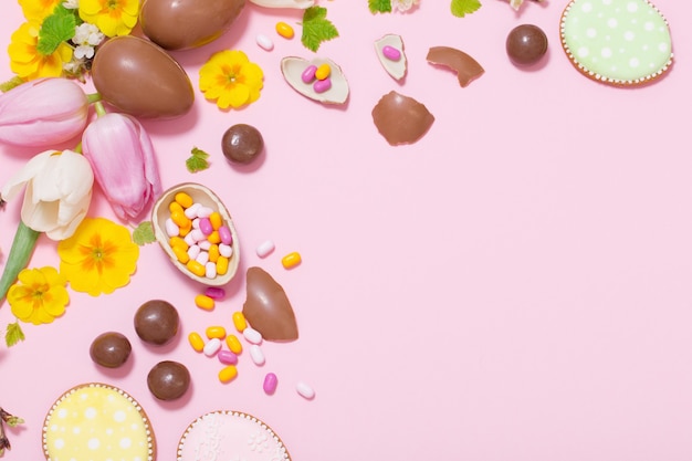 Easter pink background with eggs and flowers