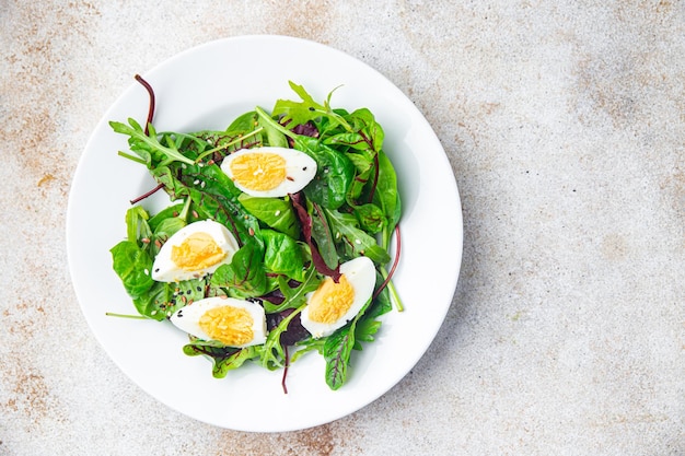 Easter salad egg green leaves mix fresh portion dietary healthy meal food snack on the table