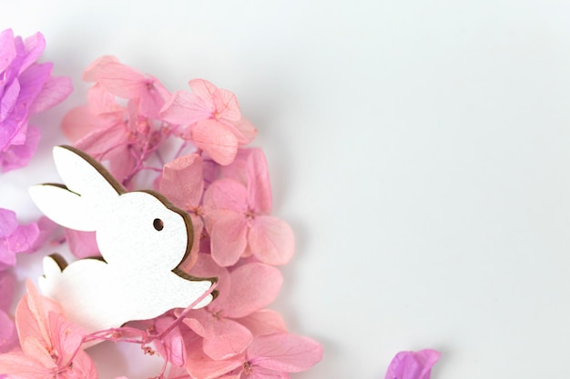 Easter spring flowers and rabbit Holiday decoration background with copy space flat lay top view photo