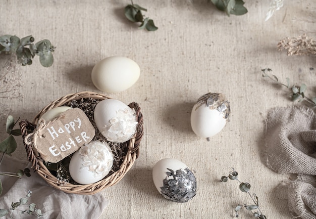 Easter still life with eggs in a wicker basket. Happy Easter concept.