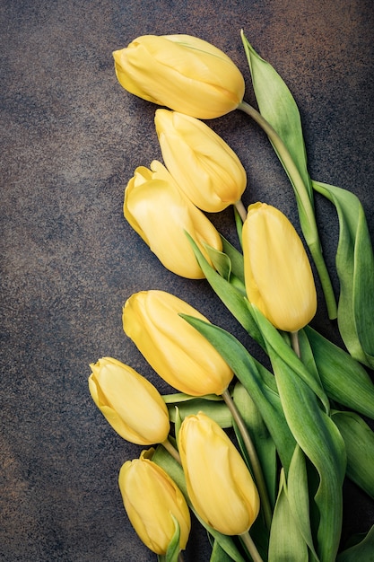 Easter surface with yellow tulips. Greeting card for mother's day. Copy space