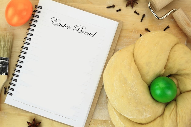 Easter sweet bread dough and recipe book on the table