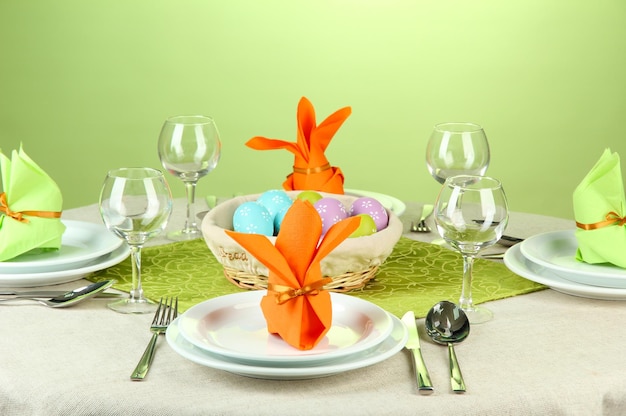 Easter table setting on color background