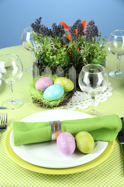 Easter table setting on color background