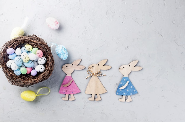 Easter table with colored Decorative eggs in the nest and tulips