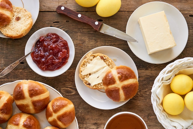 Easter table with cross buns and colored yellow eggs