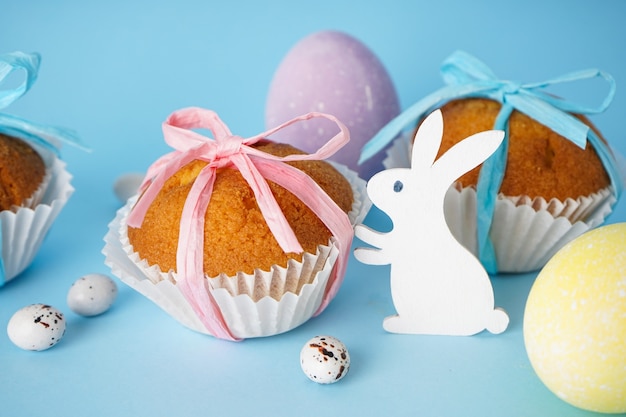 Easter treats, colorful cupcakes on a blue background. Close-up