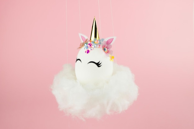 Easter unicorn egg flying on cloud on pastel pink background happy easter banner kids activity inspi