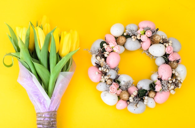 Photo easter wreath of colorful decorative eggs and flowers