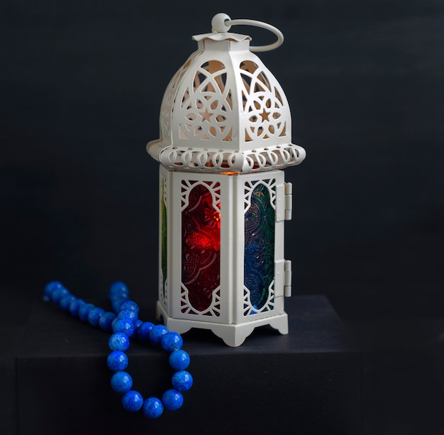 Eastern lantern with candle and rosary beads