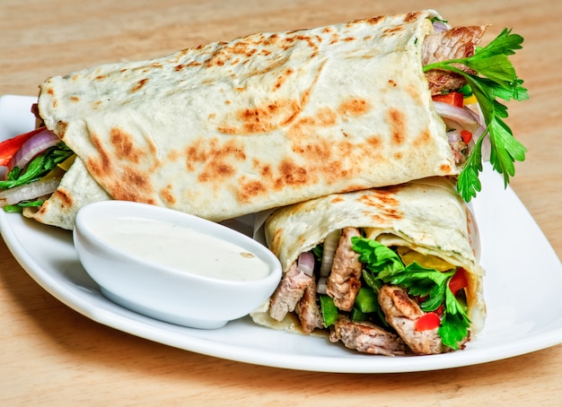 Eastern traditional shawarma plate with sauce.