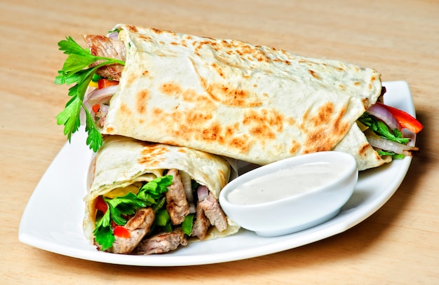 Eastern traditional shawarma plate with sauce.