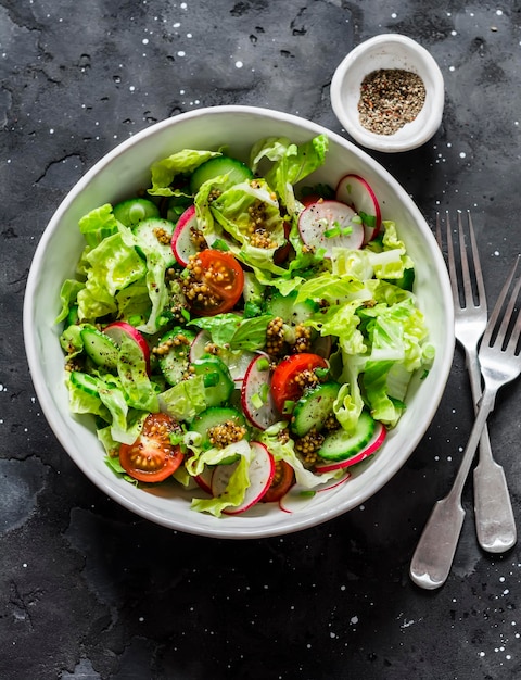 Easy vegetarian vegetable salad with fresh vegetables Cherry tomatoes romano lettuce cucumbers radishes