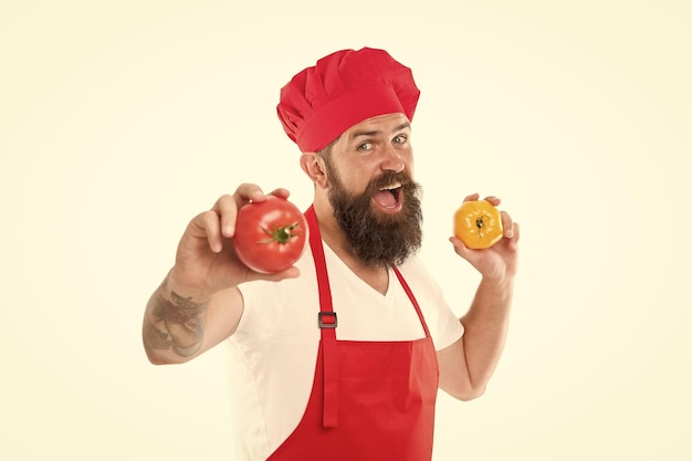 Eat fresh tomato Pick one Healthy cooking concept Man with beard on white background Chef holds tomatoes Cook in uniform holds vegetables Tomato sauce recipe Ripe tomato for delicious meal