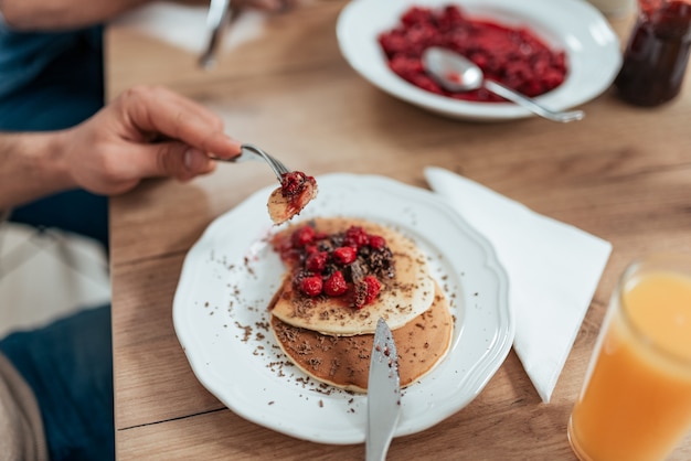 Eating delicious homemade pancakes.