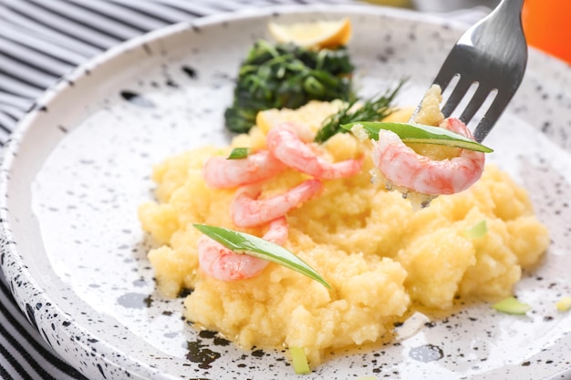 Eating of fresh tasty shrimp and grits closeup