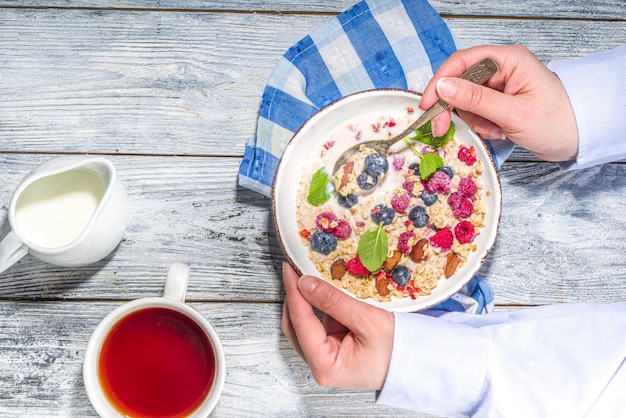 Eating healthy breakfast. Close-up video of eating on granola corn flakes with milk, fresh berry an nuts