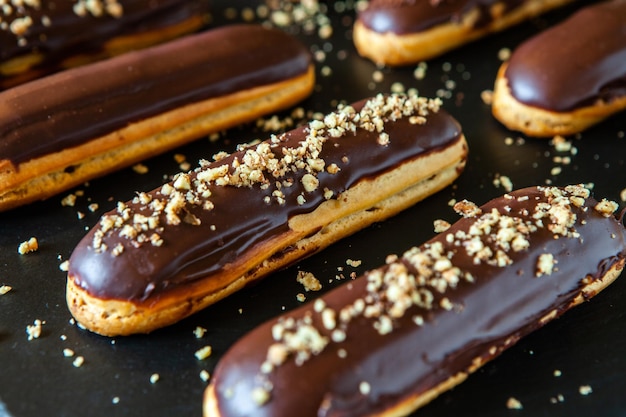 Eclairs with chocolate topping on serving plate