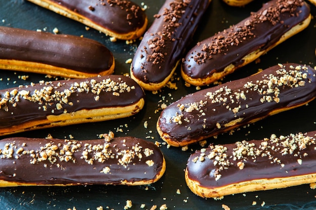 Eclairs with chocolate topping on serving plate