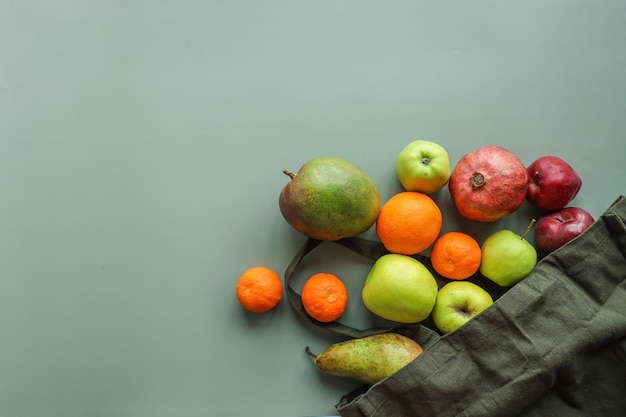 Eco bag with products on color background