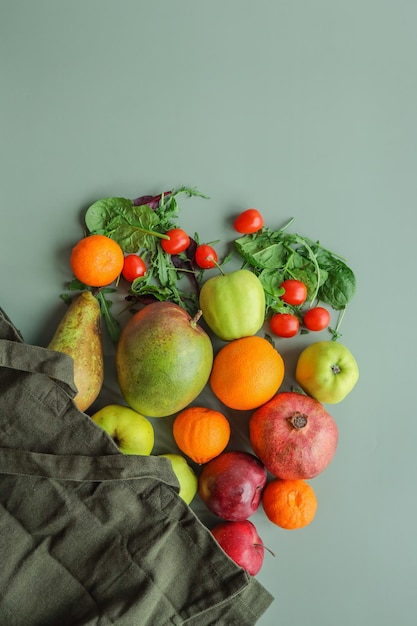 Eco bag with products on color background