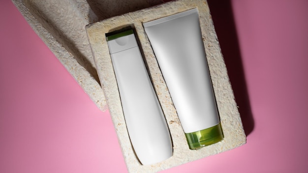 Eco box mockup with containers for cosmetics white tube and bottle for cosmetics