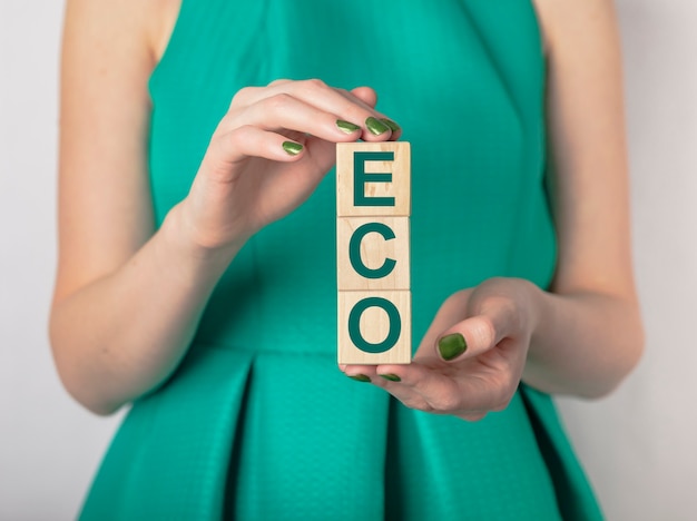 Eco concept. inscription in women hands in green dress.