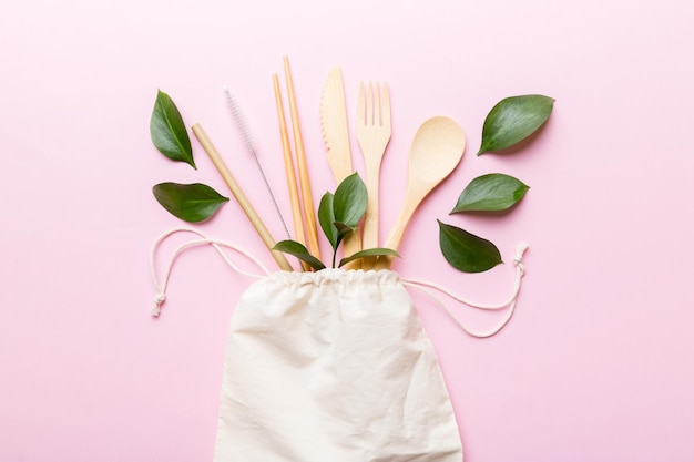 Eco friendly reusable recyclable white eco bag with kitchenware on Colored background Concept zero waste