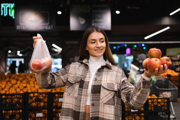 Eco friendly woman buys apples in the supermarket