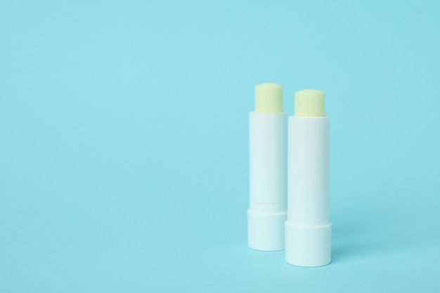 Eco lipstick on blue background, space for text