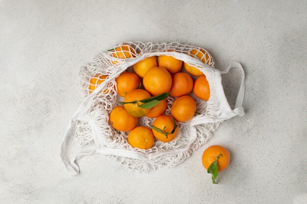 Eco  , organic ripe clementines in cotton mesh bag