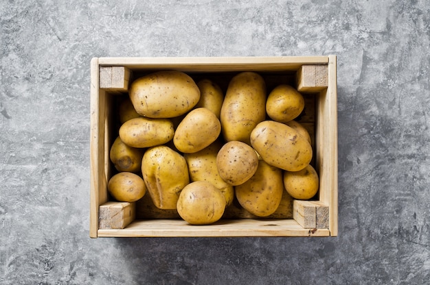 Eco packaging for vegetables, plastic free. Potatoes in a wooden box, supermarket.