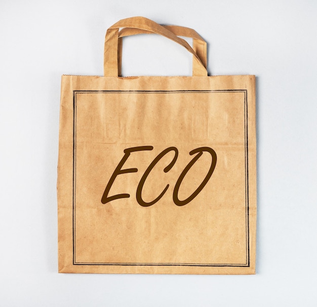 Eco word on brown paper craft shopping bag photo