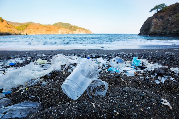 Ecological concept. Beach pollution -trash on sea beach