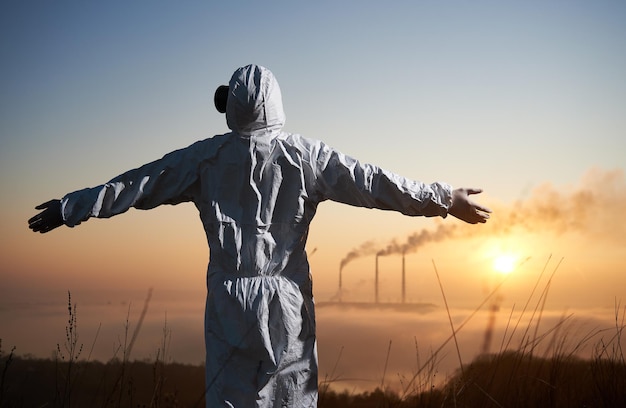 Ecologist spreading hands to sides at thermal power station