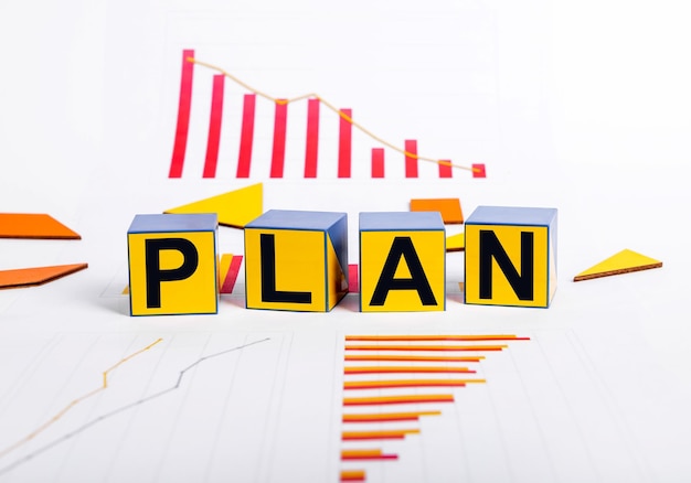 Economic crisis recovery Cubes with word plan and charts showing recession in business Strategy for overcoming financial problems and slowdown