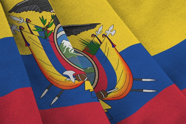 Ecuador flag with big folds waving close up under the studio light indoors The official symbols and colors in banner