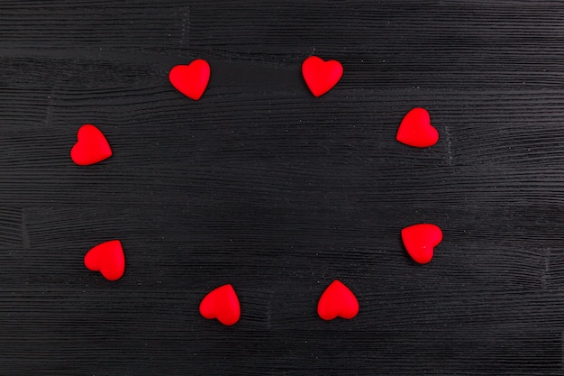 Ed hearts on black wooden background