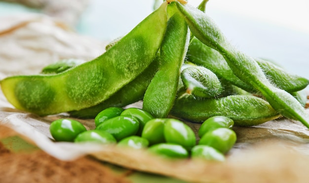 Edamame or soybeans on brown paper on sackcloth