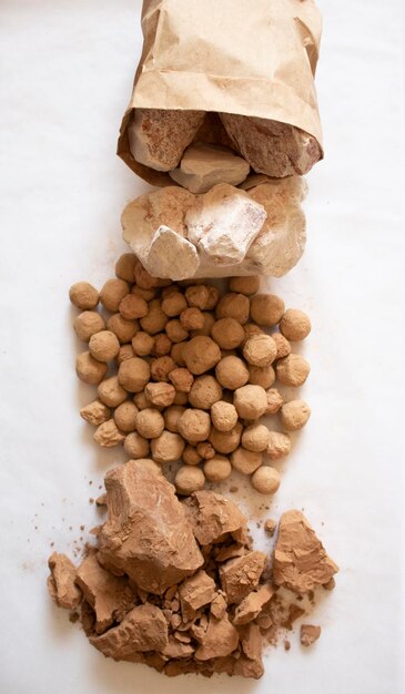 Edible caramel clay stones with white and brown clay stones on a white background flat lay