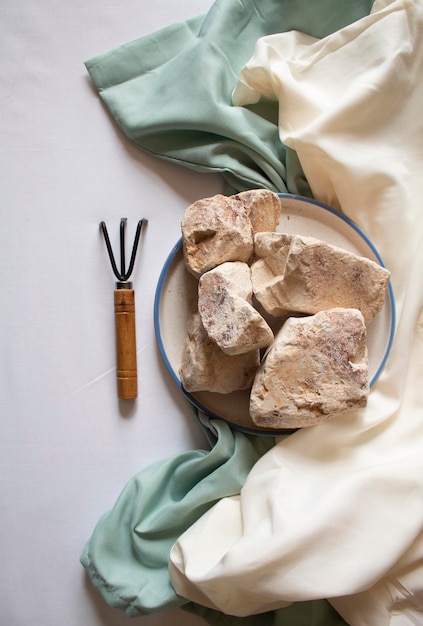 Edible white clay stones with a small garden wrack minimal flat lay