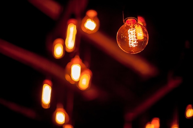 Edison lamp on a black background Incandescent lightbulb with a dark background with bokeh