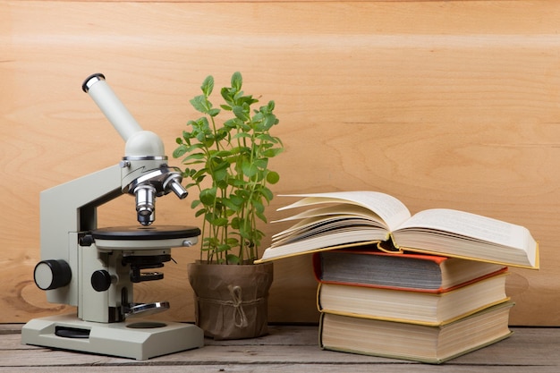 Education concept books and microscope on the desk in the auditorium