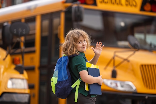 Photo education concept schoolkid with backpack and book getting on the school bus american school back to