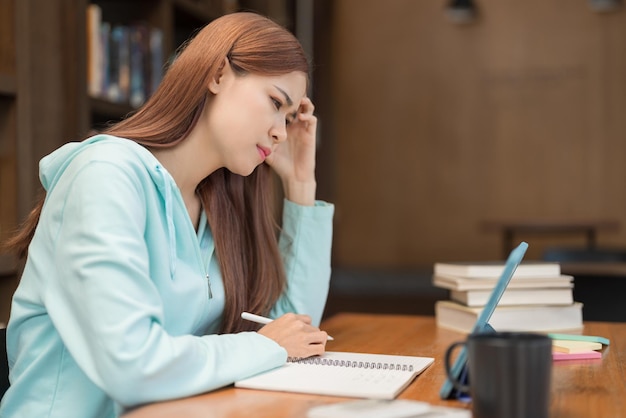 Education concept Teenage girl feel confused while watching video math tutorial of tutor on tablet